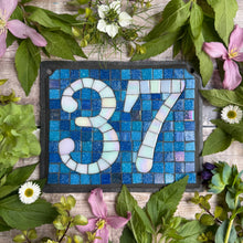 White iridescent number with a denim blue background