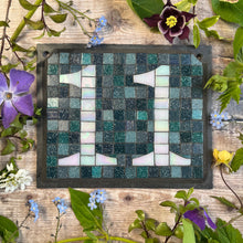 White iridescent number with a grey/green background
