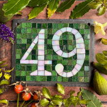 White iridescent number with a dark green background
