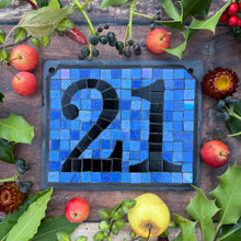 Black number with a periwinkle blue background