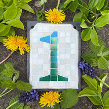 Green iridescent number with a white background