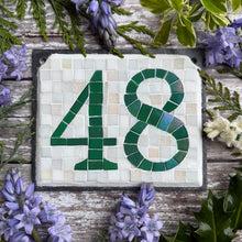 Green iridescent number with a white background