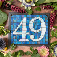 White iridescent number with a denim blue background