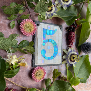 Green iridescent number with a white background