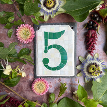 Green iridescent number with a white background