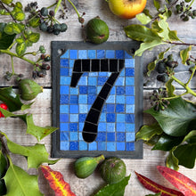 Black number with a periwinkle blue background