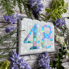 Green iridescent number with a white background