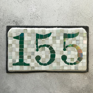 Green iridescent number with a white background