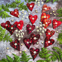 Fabric heart brooches in reds